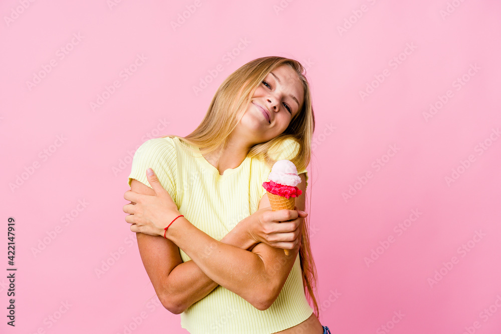 Young russian woman eating an ice cream isolated hugs, smiling carefree and happy. Young russian woman eating an ice cream isolated hugs, smiling carefree and happy.