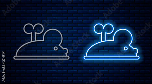 Glowing neon line Clockwork mouse icon isolated on brick wall background. Wind up mouse toy. Vector