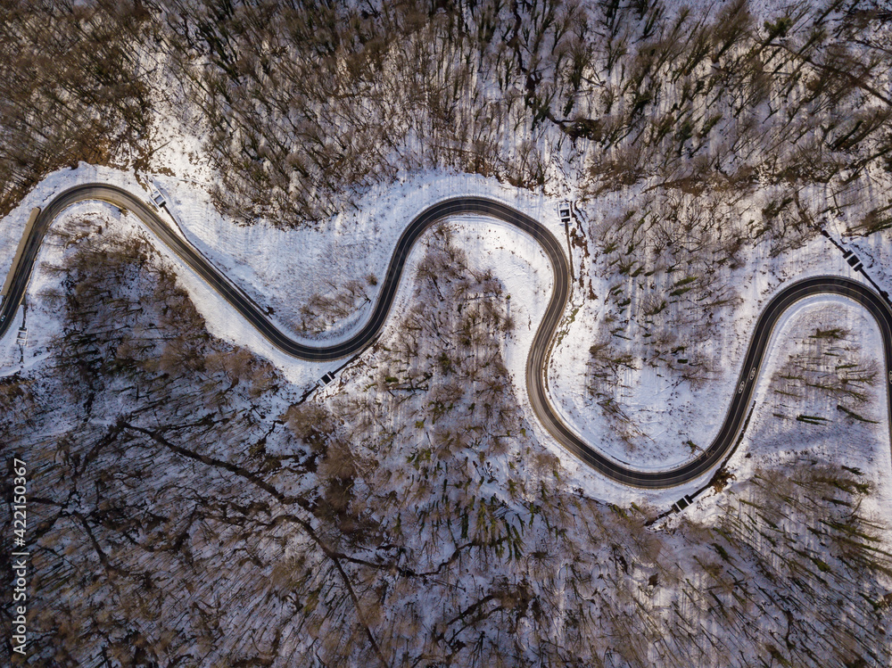 Winter aerial top view of the road to ski resort Krasnaya Polyana. Beautiful winter landscape from drone.