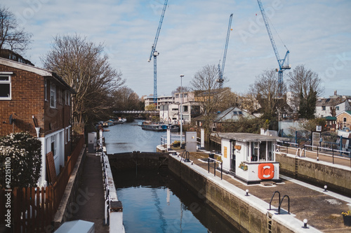 Building crane and building under construction against blue sky next to the Grand Union Canal. photo