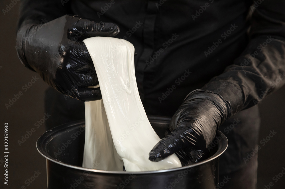 Cheese maker preparing mozzarella cheese