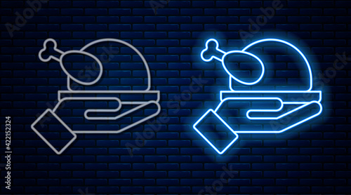 Glowing neon line Roasted turkey or chicken icon isolated on brick wall background. Vector