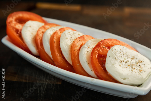 Obraz na płótnie tomatoes and cheese in Italian - mozzarella w salonie