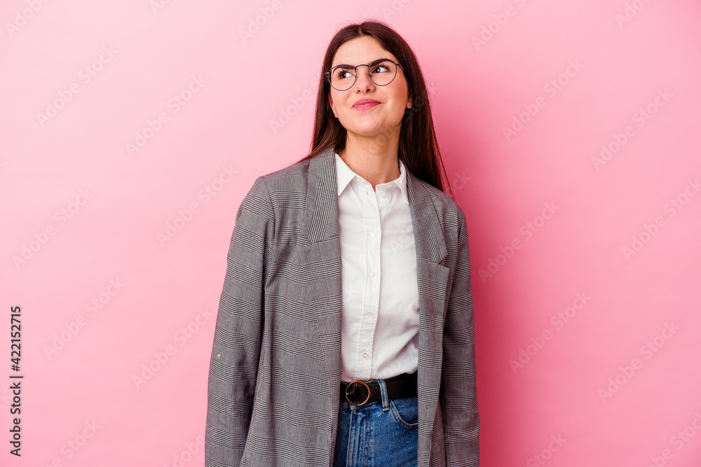 Young caucasian business woman isolated on pink background dreaming of achieving goals and purposes Young caucasian business woman isolated on pink background dreaming of achieving goals and purposes