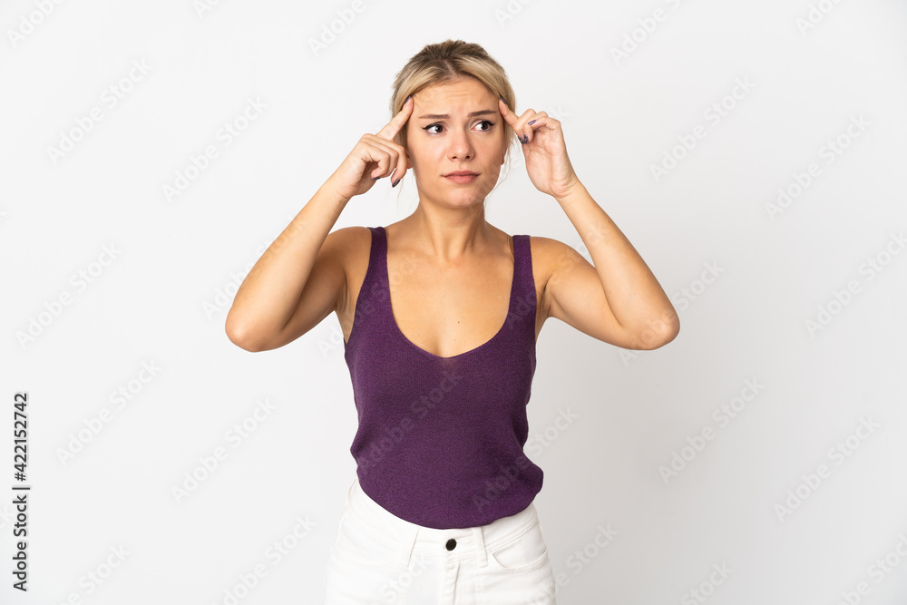 Young Russian woman isolated on white background having doubts and thinking