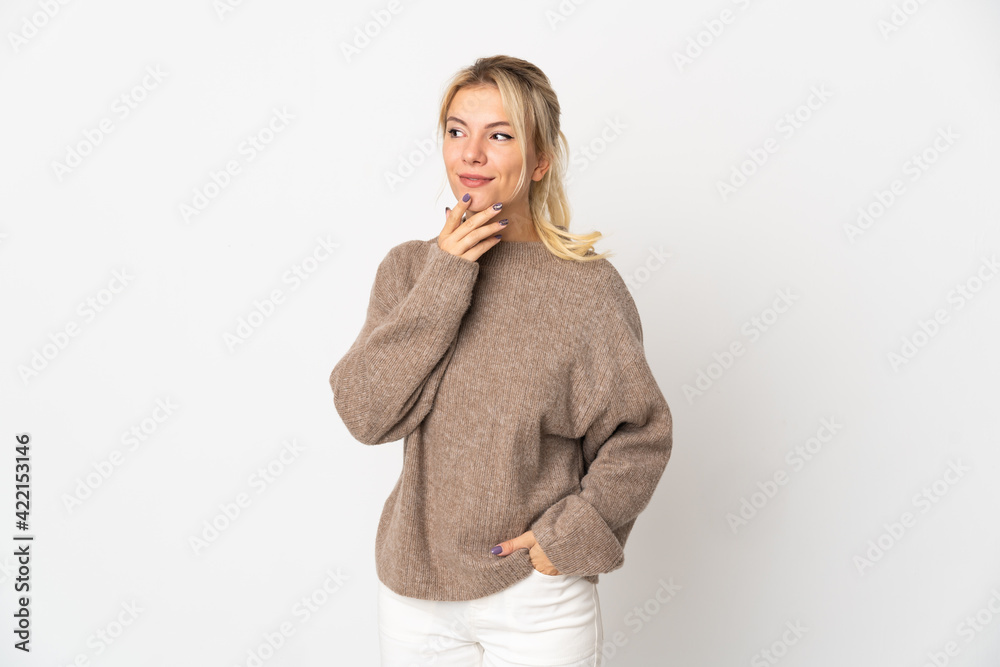 Young Russian woman isolated on white background looking up while smiling Young Russian woman isolated on white background looking up while smiling