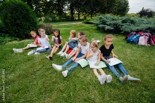 A teacher teaches a class of children in an outdoor Park. Back to school, learning during the pandemic