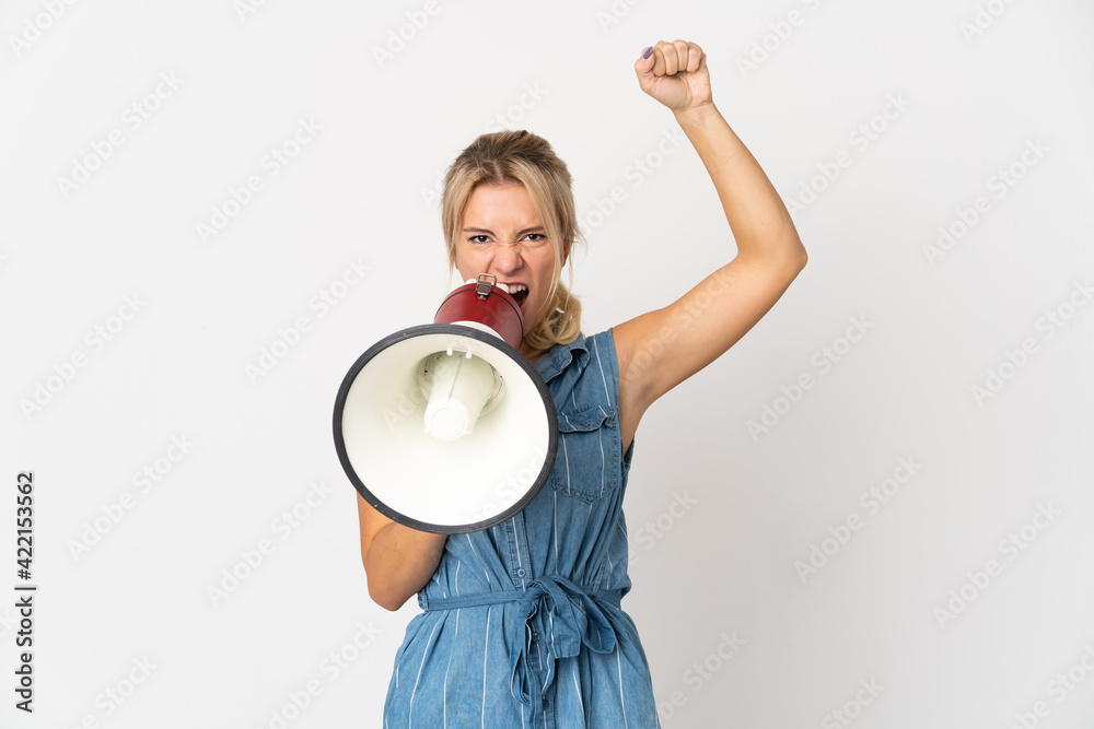 Young Russian woman isolated on white background shouting through a megaphone to announce something Young Russian woman isolated on white background shouting through a megaphone to announce something