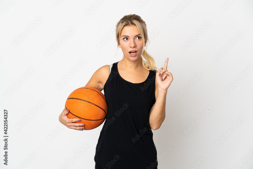Young Russian woman playing basketball isolated on white background thinking an idea pointing the finger up