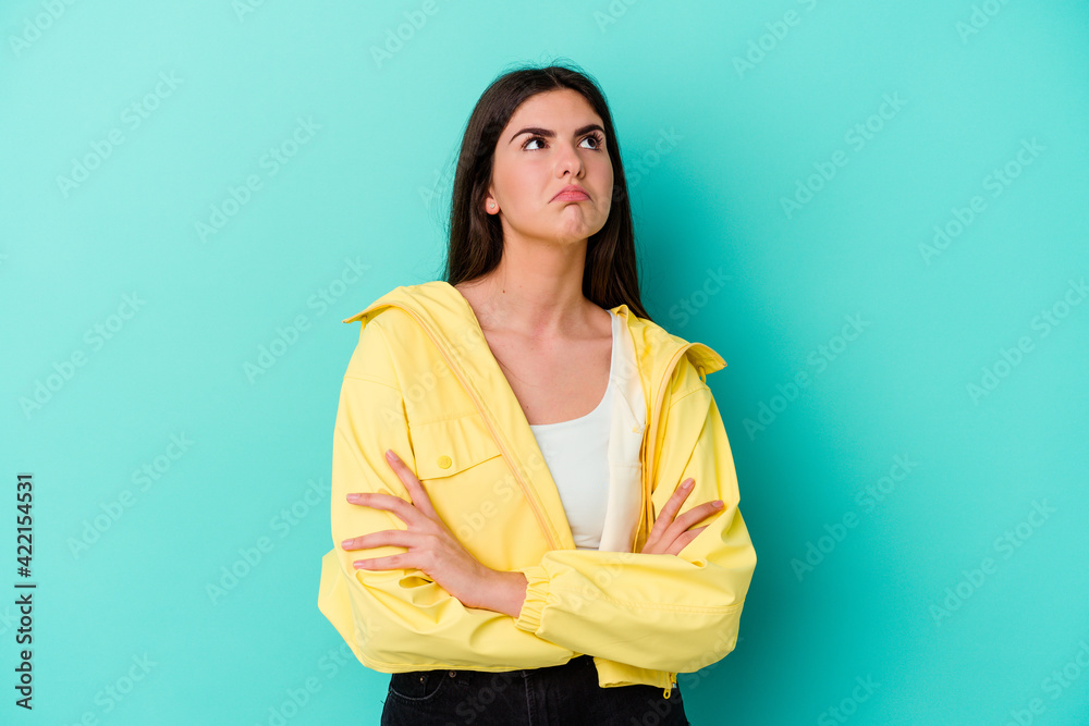 Young caucasian woman isolated on blue background tired of a repetitive task. Young caucasian woman isolated on blue background tired of a repetitive task.