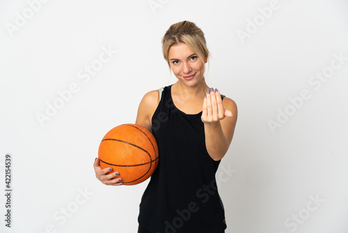 Young Russian woman playing basketball isolated on white background inviting to come with hand. Happy that you came