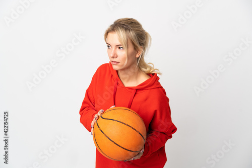 Young Russian woman isolated on white background playing basketball
