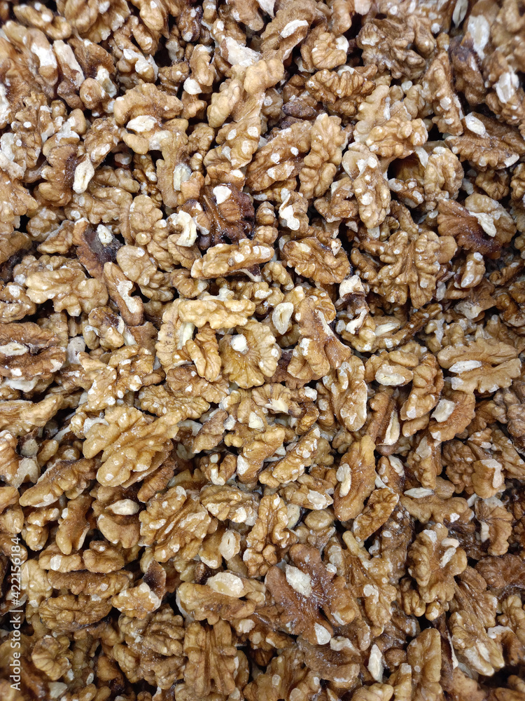 Walnut. The background is made of peeled walnuts. Full frame Walnut. The background is made of peeled walnuts. Full frame