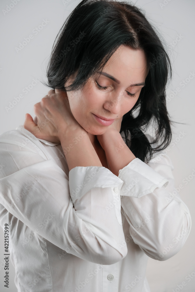 Portrait of beautiful mature brunette woman isolated on gray white background, copy space Portrait of beautiful mature brunette woman isolated on gray white background, copy space