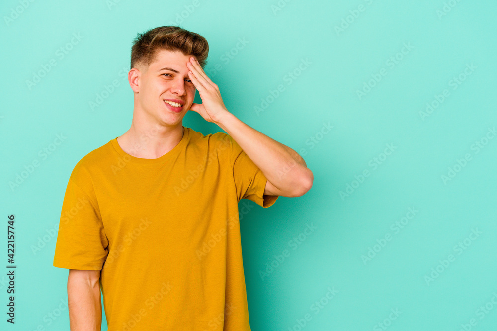 Young caucasian man isolated on blue background laughing happy, carefree, natural emotion. Young caucasian man isolated on blue background laughing happy, carefree, natural emotion.