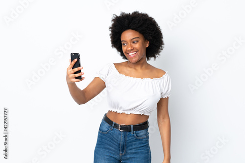 Young African American woman isolated on white background making a selfie