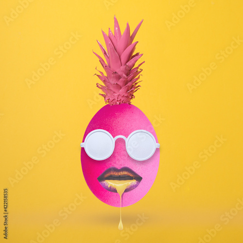 Creative Easter egg made of pineapple and sunglasses, and mouth on yellow background. Spring minimal concept. April holiday composition. Top view.
