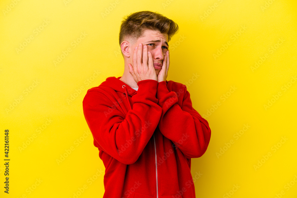 Fototapeta premium Young caucasian man isolated on yellow background whining and crying disconsolately.