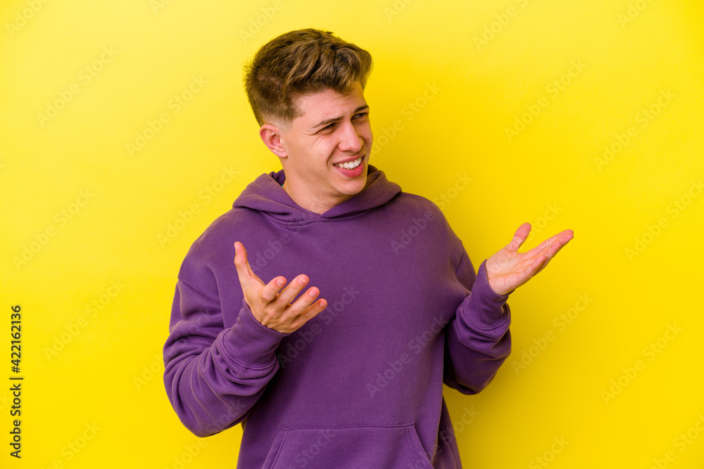 Young caucasian man isolated on yellow background joyful laughing a lot. Happiness concept. Young caucasian man isolated on yellow background joyful laughing a lot. Happiness concept.