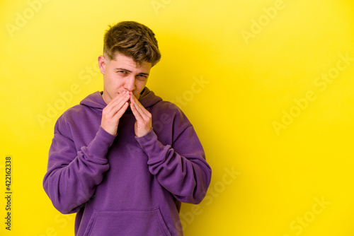 Young caucasian man isolated on yellow background making up plan in mind, setting up an idea. © Asier