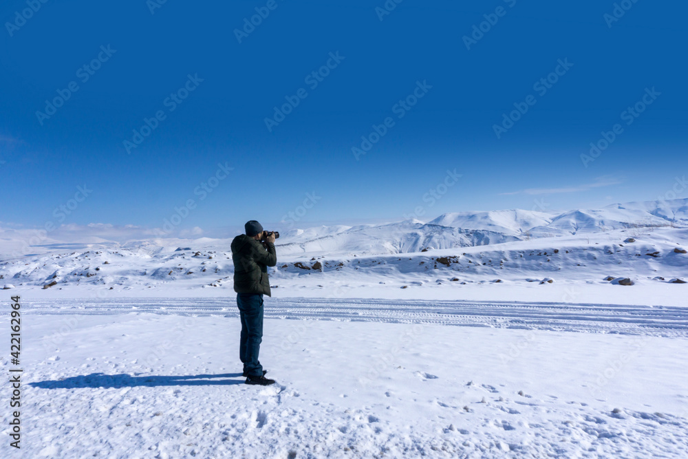 Photographer taking a photo rear view