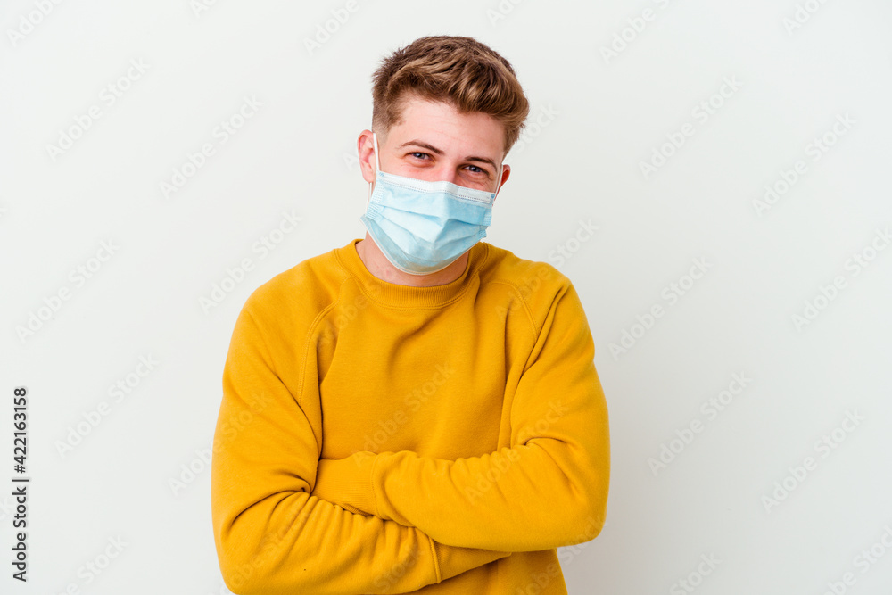 Young man wearing a mask for coronavirus isolated on white background laughing and having fun. Young man wearing a mask for coronavirus isolated on white background laughing and having fun.