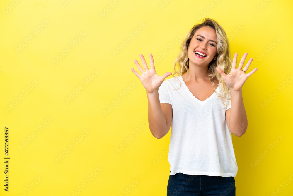 Young Brazilian woman isolated on yellow background counting ten with fingers Young Brazilian woman isolated on yellow background counting ten with fingers