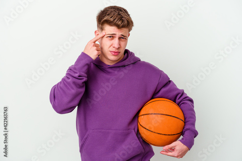 Young caucasian man playing basketball isolated background showing a disappointment gesture with forefinger.