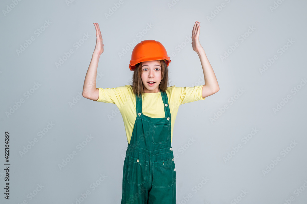 girl child wearing uniform and helmet while working in workshop, overworked girl child wearing uniform and helmet while working in workshop, overworked