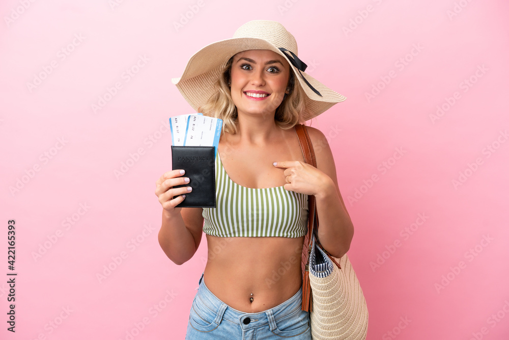 Young Brazilian woman in swimsuit in summer holidays isolated on pink background with surprise facial expression