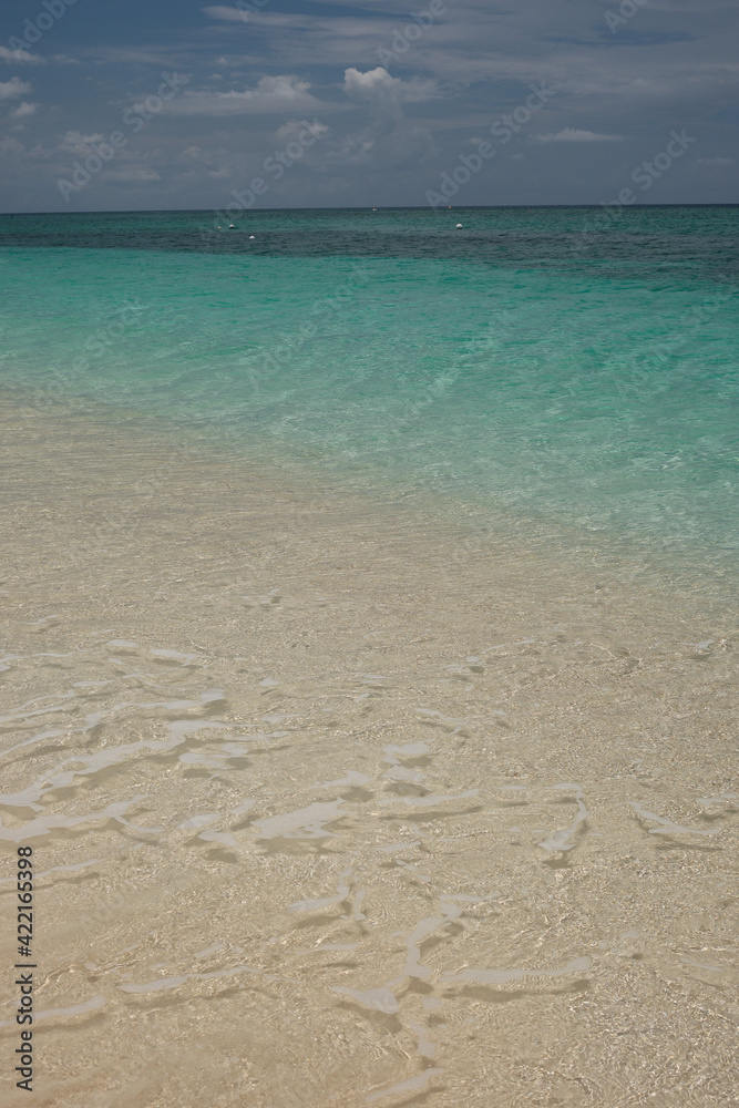 Small waves lap on the shore of the Cayman Islands in the British West Indies