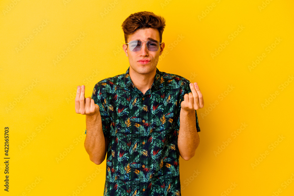 Young caucasian man wearing a Hawaiian shirt isolated on yellow background showing that she has no money. Young caucasian man wearing a Hawaiian shirt isolated on yellow background showing that she has no money.