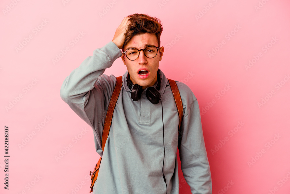 Young student man isolated on pink background tired and very sleepy keeping hand on head. Young student man isolated on pink background tired and very sleepy keeping hand on head.