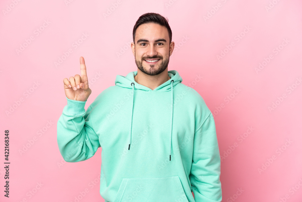 Young caucasian handsome man isolated on pink background pointing up a great idea Young caucasian handsome man isolated on pink background pointing up a great idea