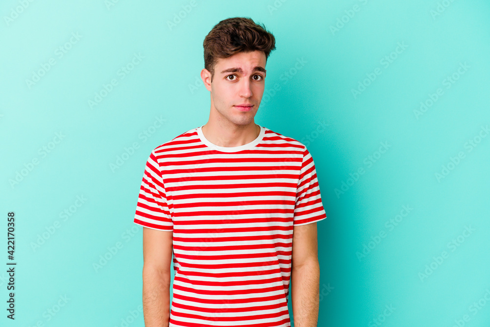Young caucasian man isolated on blue background sad, serious face, feeling miserable and displeased. Young caucasian man isolated on blue background sad, serious face, feeling miserable and displeased.