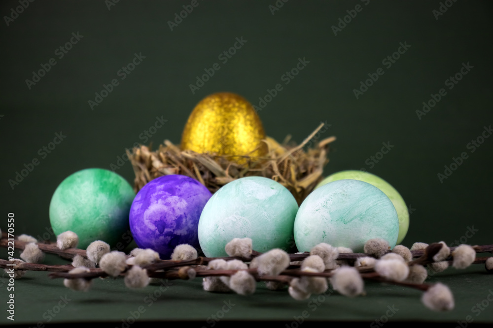 image of festive Easter eggs and pussy willow branches on the table close-up.