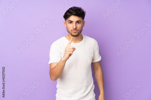 Arabian handsome man over isolated background frustrated and pointing to the front
