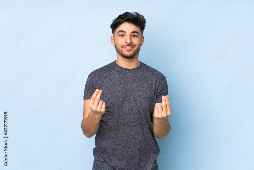 Arabian handsome man over isolated background making money gesture