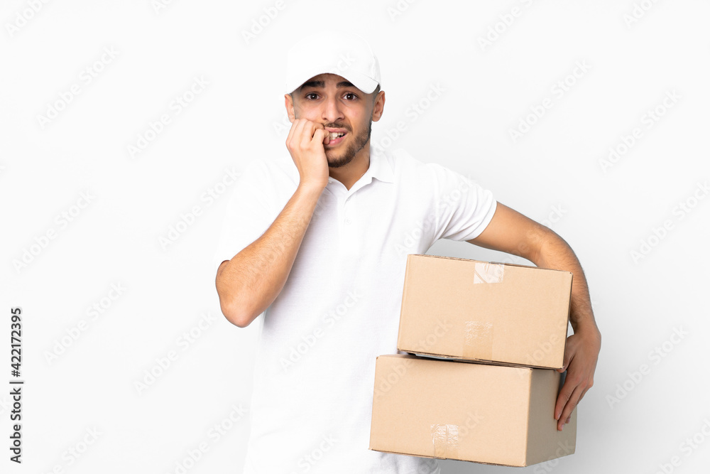 Delivery Arabian man isolated on blue background nervous and scared Delivery Arabian man isolated on blue background nervous and scared