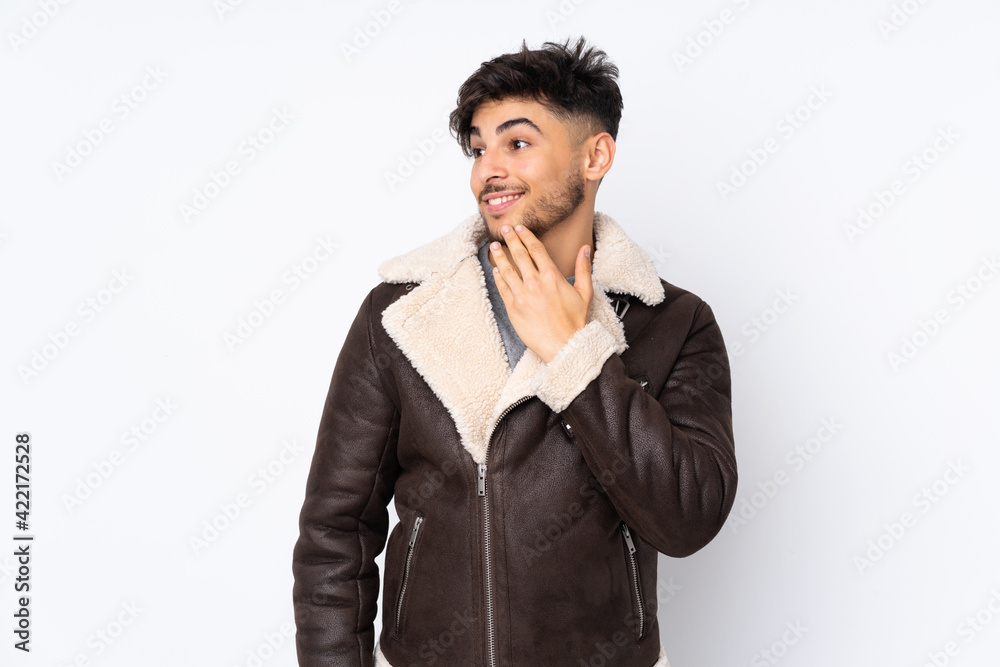 Arabian handsome man over isolated background looking up while smiling Arabian handsome man over isolated background looking up while smiling