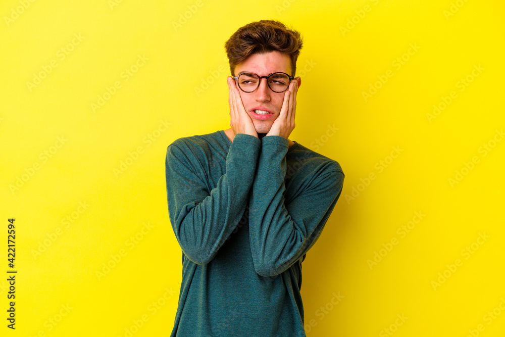 Young caucasian man isolated on yellow background whining and crying disconsolately.