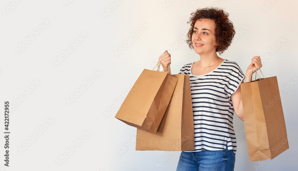 Happy young woman with shopping bags on white background Happy young woman with shopping bags on white background