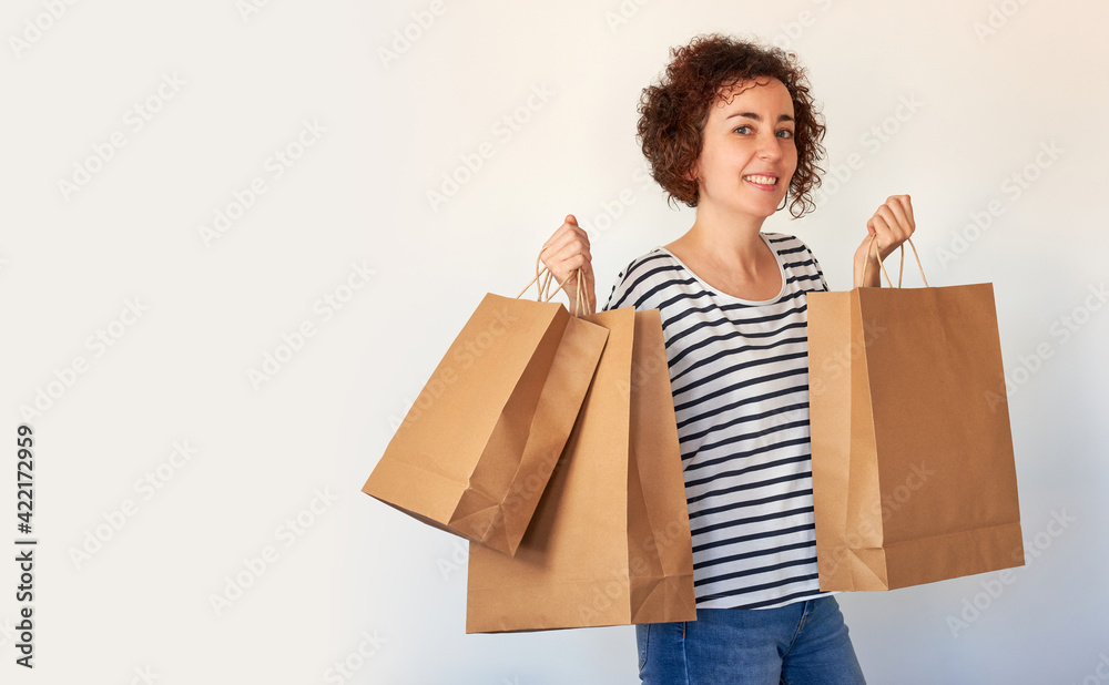 Happy young woman with shopping bags on white background Happy young woman with shopping bags on white background