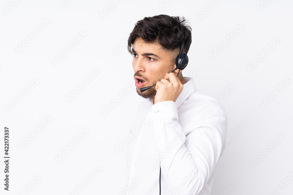 Telemarketer Arabian man working with a headset isolated on white background Telemarketer Arabian man working with a headset isolated on white background