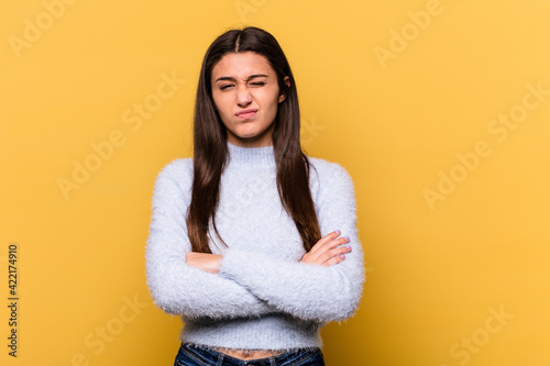Young Indian woman isolated on yellow background unhappy looking in camera with sarcastic expression.