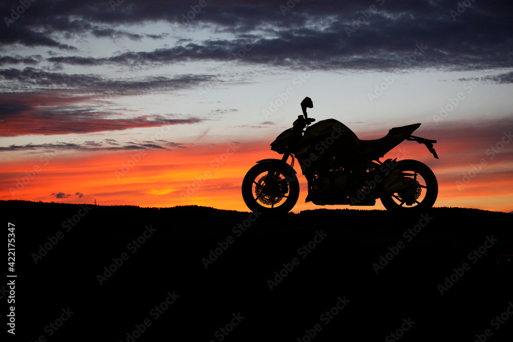 Fototapeta premium Motorbike parking with sunset background. Biker ride motorcycle. Silhouette of motobike. Trip and lifestyle motorbike Concept.