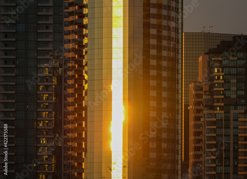 Orange sunset reflecting off a city building