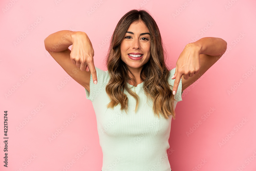 Young caucasian woman isolated points down with fingers, positive feeling. Young caucasian woman isolated points down with fingers, positive feeling.
