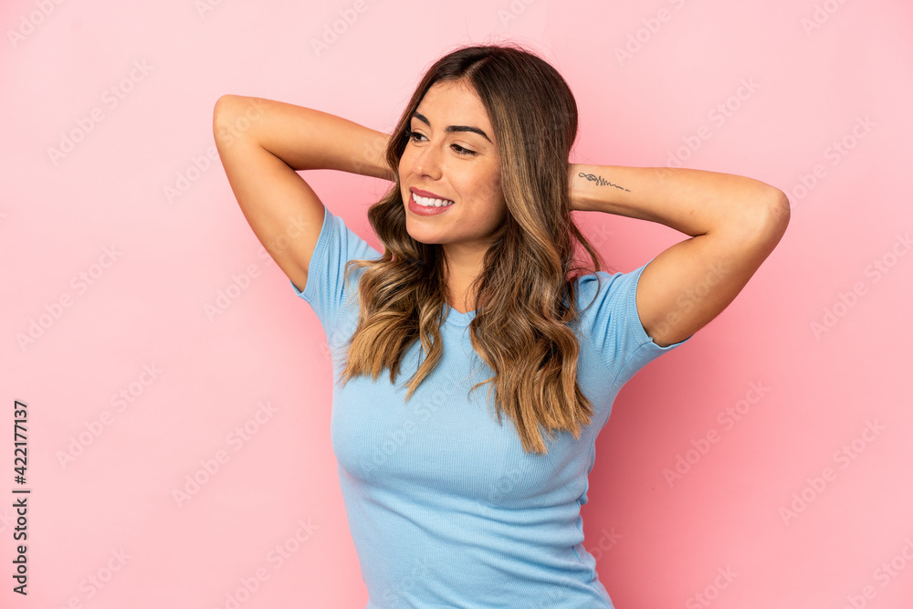 Young caucasian woman isolated feeling confident, with hands behind the head. Young caucasian woman isolated feeling confident, with hands behind the head.