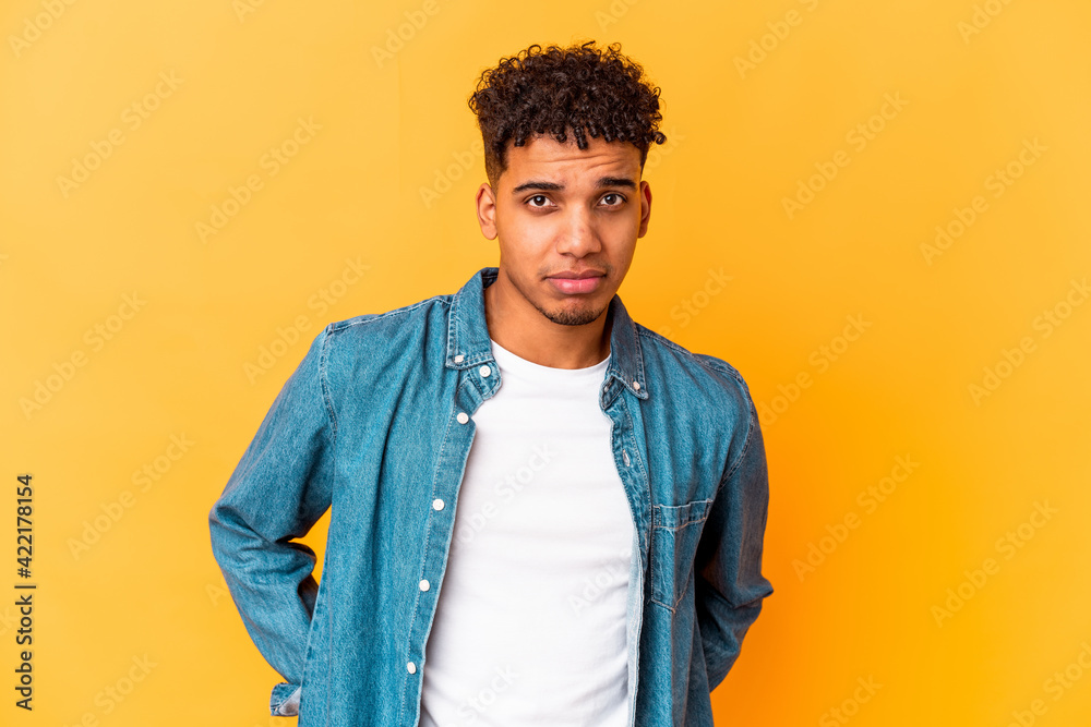 Young african american curly man isolated on purple sad, serious face, feeling miserable and displeased. Young african american curly man isolated on purple sad, serious face, feeling miserable and displeased.